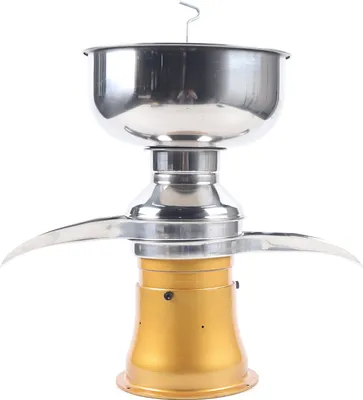 A stainless steel and gold electric milk separator.