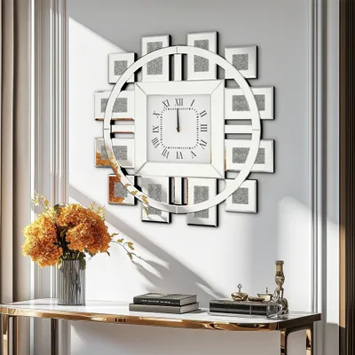 A decorative wall clock with a circular frame and square photo frames arranged around it, mounted on a white wall above a console table with books and decorative items.