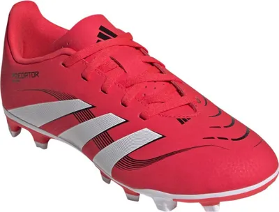 A red Adidas Predator children's soccer cleat is shown from a side angle against a white background.