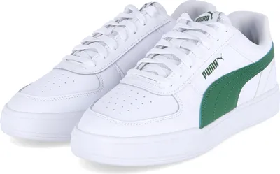 A pair of white Puma sneakers with green accents.