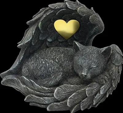 A statue of a sleeping cat curled up within angel wings, with a heart shape in the center.