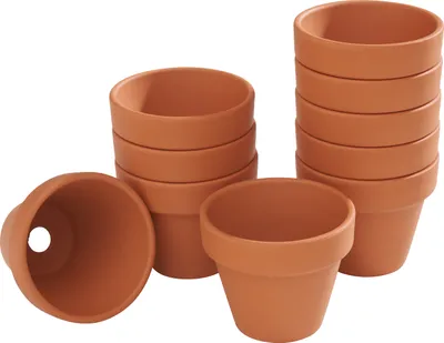 Several small terracotta pots are stacked and arranged on a white background.