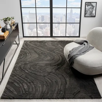 A modern living room with a large window overlooking a city skyline, featuring a dark gray rug with a wavy pattern.