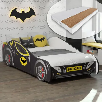 A child's bed designed to look like a Batcar, with Batman-themed pillows and wall decor.