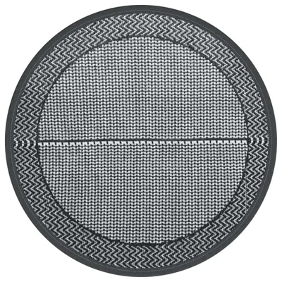 A circular outdoor rug with a geometric pattern.