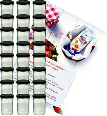 A set of glass jars with black lids, along with a recipe booklet and a packet of gelling agent, arranged on a white surface with some strawberries and a checkered cloth.