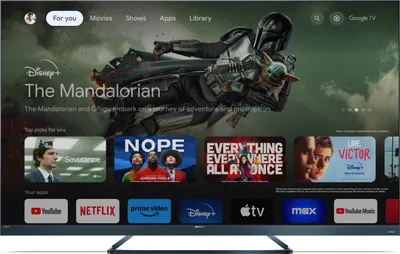 A television screen displaying a smart TV interface with various streaming service logos and content previews.