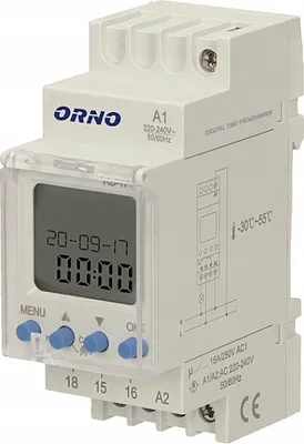 A digital time programmer device mounted on a DIN rail.