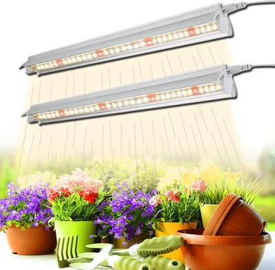 Two LED grow lights are shown above a variety of potted plants and gardening tools, with light rays emanating from the lamps.