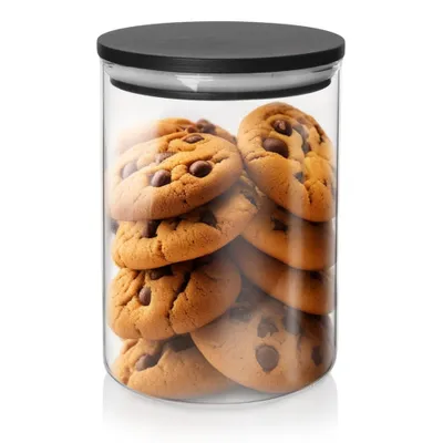 A glass jar filled with chocolate chip cookies.