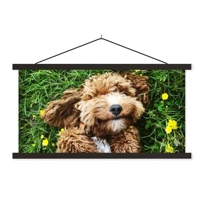Produktbild von MuchoWow® Textilposter Welpe im Gras liegend 150x75 cm mit schwarzem Rahmen - Posterleiste