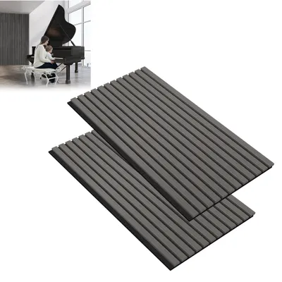 A person playing a piano in a room with acoustic panels on the wall.