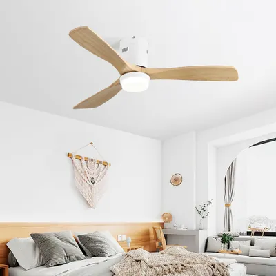 A modern bedroom with a white ceiling fan with wooden blades and an integrated LED light.