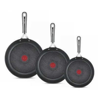 Three frying pans of different sizes are arranged diagonally on a white background.