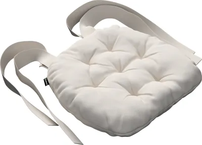 A white tufted seat cushion with straps.