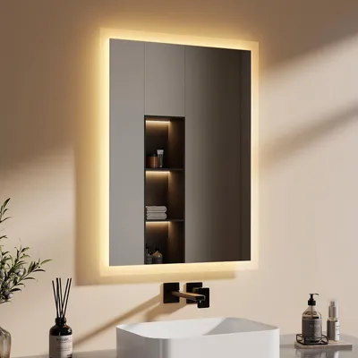 A modern bathroom vanity with a lit mirror, sink, and faucet.