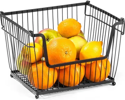 A black metal wire basket filled with various fruits.