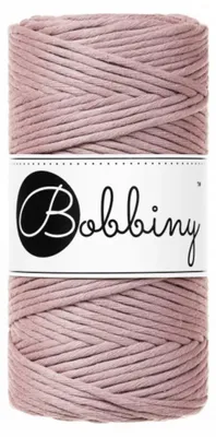 A spool of mauve macrame cord with a white label featuring the brand name "Bobbiny".