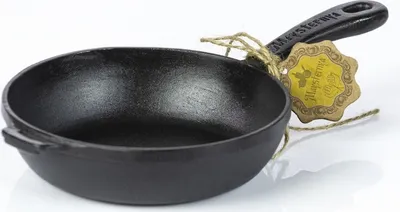 A cast iron frying pan with a tag tied to the handle.