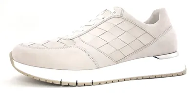 A single white sneaker with a woven pattern on a white background.