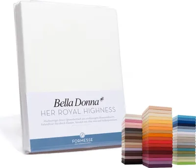 A white fitted sheet is shown standing upright, with a label indicating the brand and product name. To the right, a stack of fabric swatches in various colors is displayed.