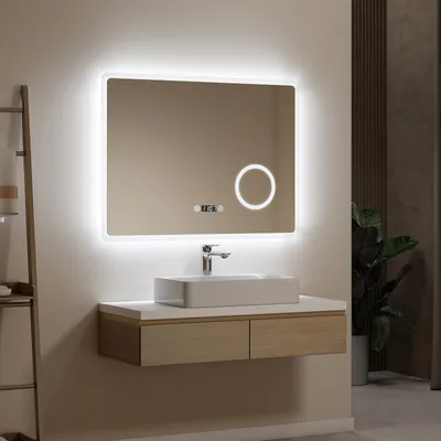 A modern bathroom vanity with a lighted mirror, sink, and faucet.