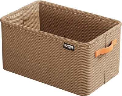 A khaki fabric storage box with orange handles and a small black label.