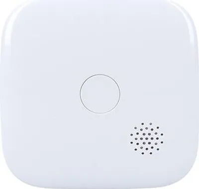 A white, square-shaped device with a circular indentation and a speaker grille.