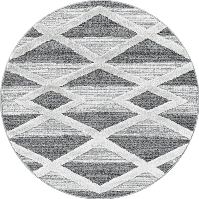 A round rug with a geometric diamond pattern.