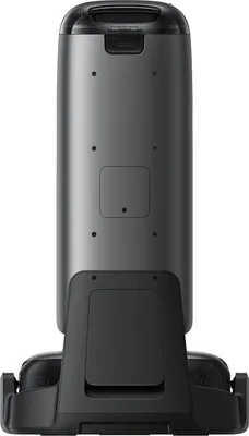 The back view of a robotic vacuum cleaner and its charging dock.