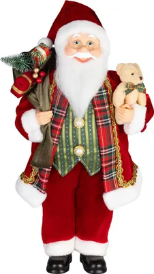 A decorative Santa Claus figure holding a gift bag and a teddy bear.