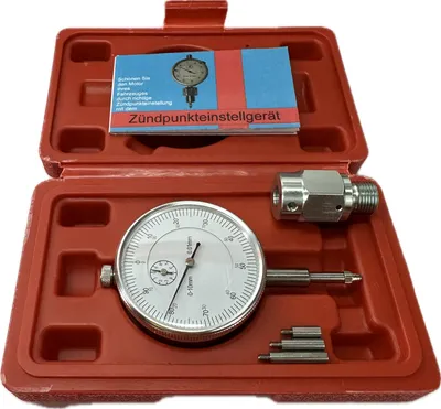 A dial indicator tool set in a red plastic case.