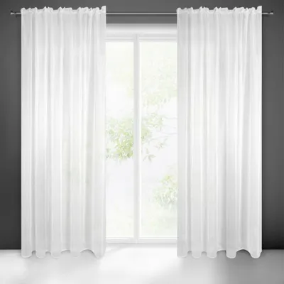 A pair of white sheer curtains hanging in front of a window.
