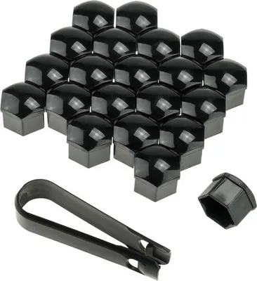 A collection of black lug nut covers and a tool to remove them, arranged on a white background.