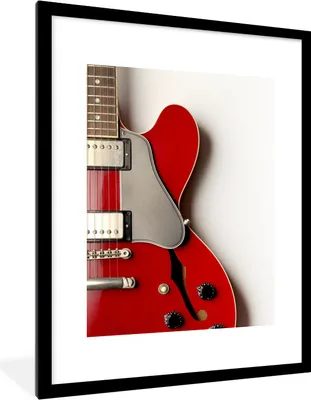 Produktbild von MuchoWow® Gerahmtes Poster Eine rote E-Gitarre 60x80 cm - Poster mit Schwarzem Bilderrahmen Wandposter Rahmen Foto Bilder - Wohnzimmer - Dekorationen - Prämie
