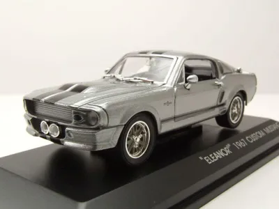 A silver 1967 Ford Shelby Mustang GT500 'Eleanor' model car displayed on a black stand.