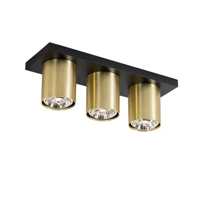 A modern ceiling spotlight with three brass-colored cylindrical lamps mounted on a black rectangular base.