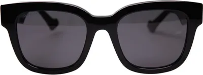 A pair of black Gucci sunglasses with gray lenses, shown from the front on a white background.