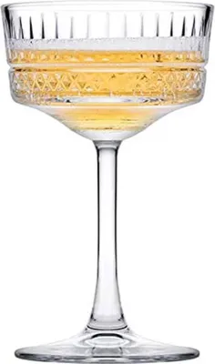 A single champagne coupe glass filled with a golden beverage, presented on a white background.