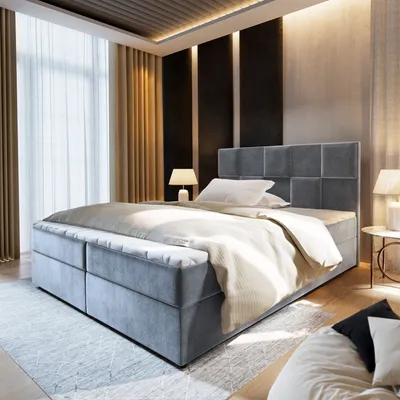 A bedroom scene with a large bed as the focal point, illuminated by soft lighting.