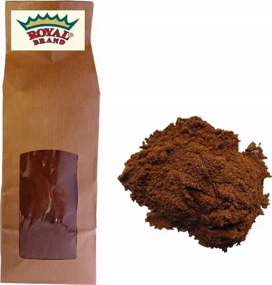 A brown paper bag with a window and a pile of brown powder next to it.