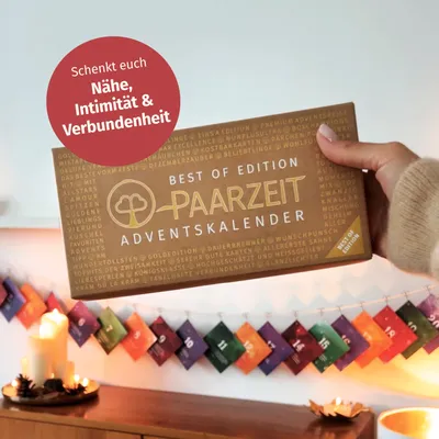 A hand holding an advent calendar box, with a string of small advent calendar envelopes hanging in the foreground.