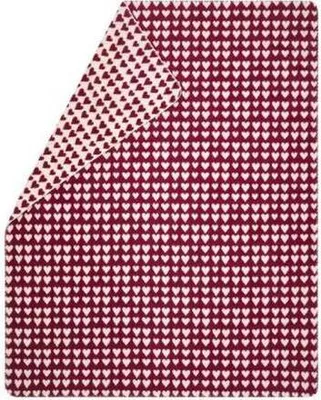 A folded blanket with a heart pattern.