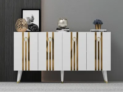 A white console table with gold accents is displayed against a gray wall.