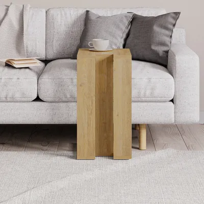 A modern living room scene with a sofa, side table, and rug.