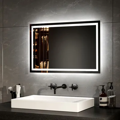 A modern bathroom vanity with a sink, faucet, and an illuminated mirror.