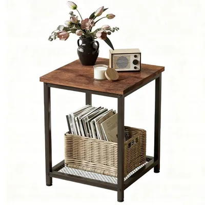 A square side table with a wooden top and metal frame, decorated with a vase of flowers, a candle, and a small radio.