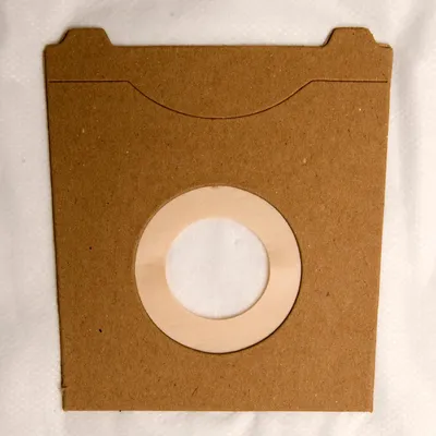 A close-up, flat lay view of a new vacuum cleaner bag.