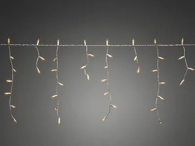 A string of icicle lights hanging against a plain background.
