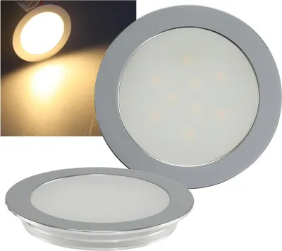 Two LED recessed lights are shown, one in the foreground and one in the background. The background also shows a lit-up surface.